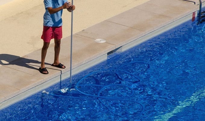 Man Cleaning The Pool